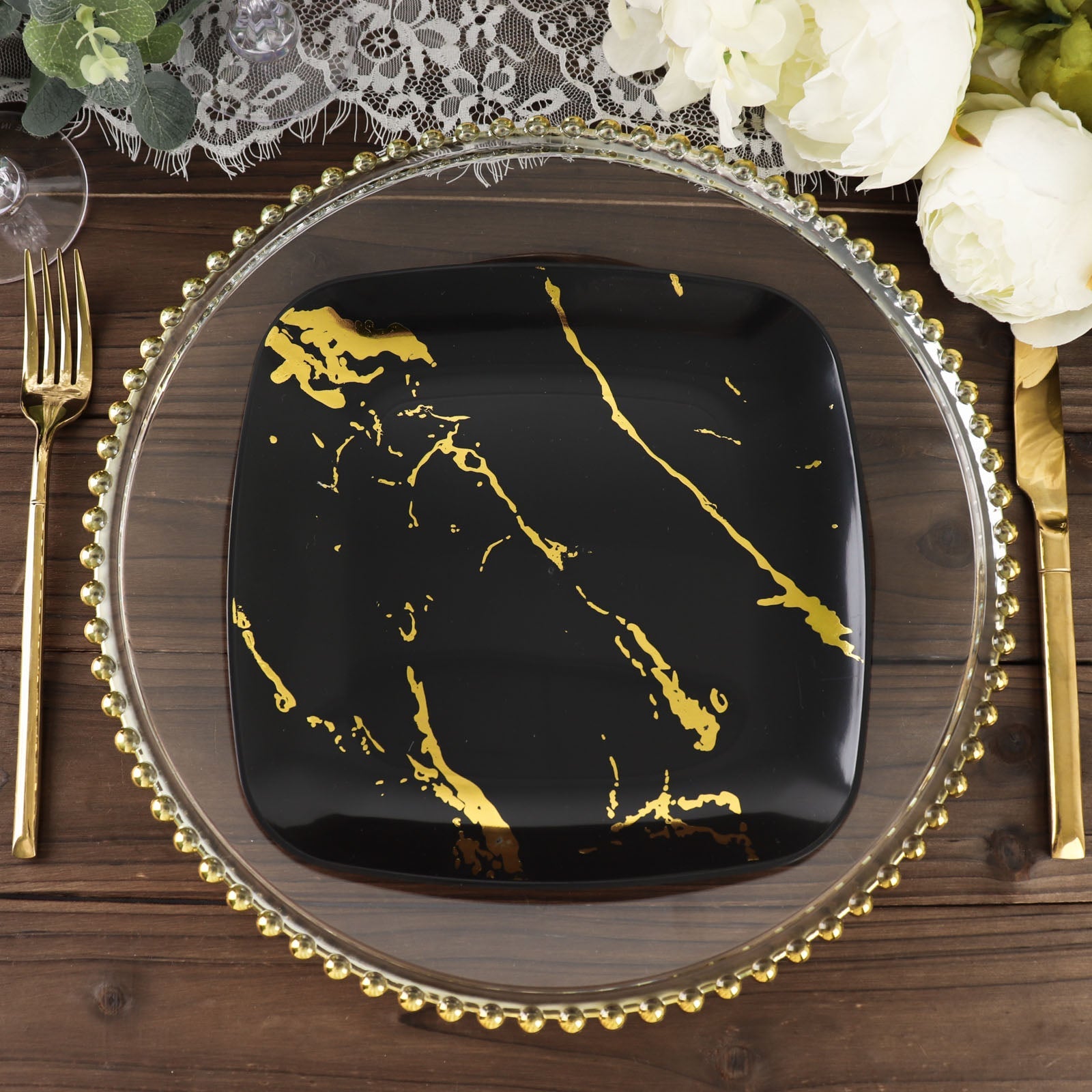 8" black and gold marble disposable dessert plate on a decorative table setting.