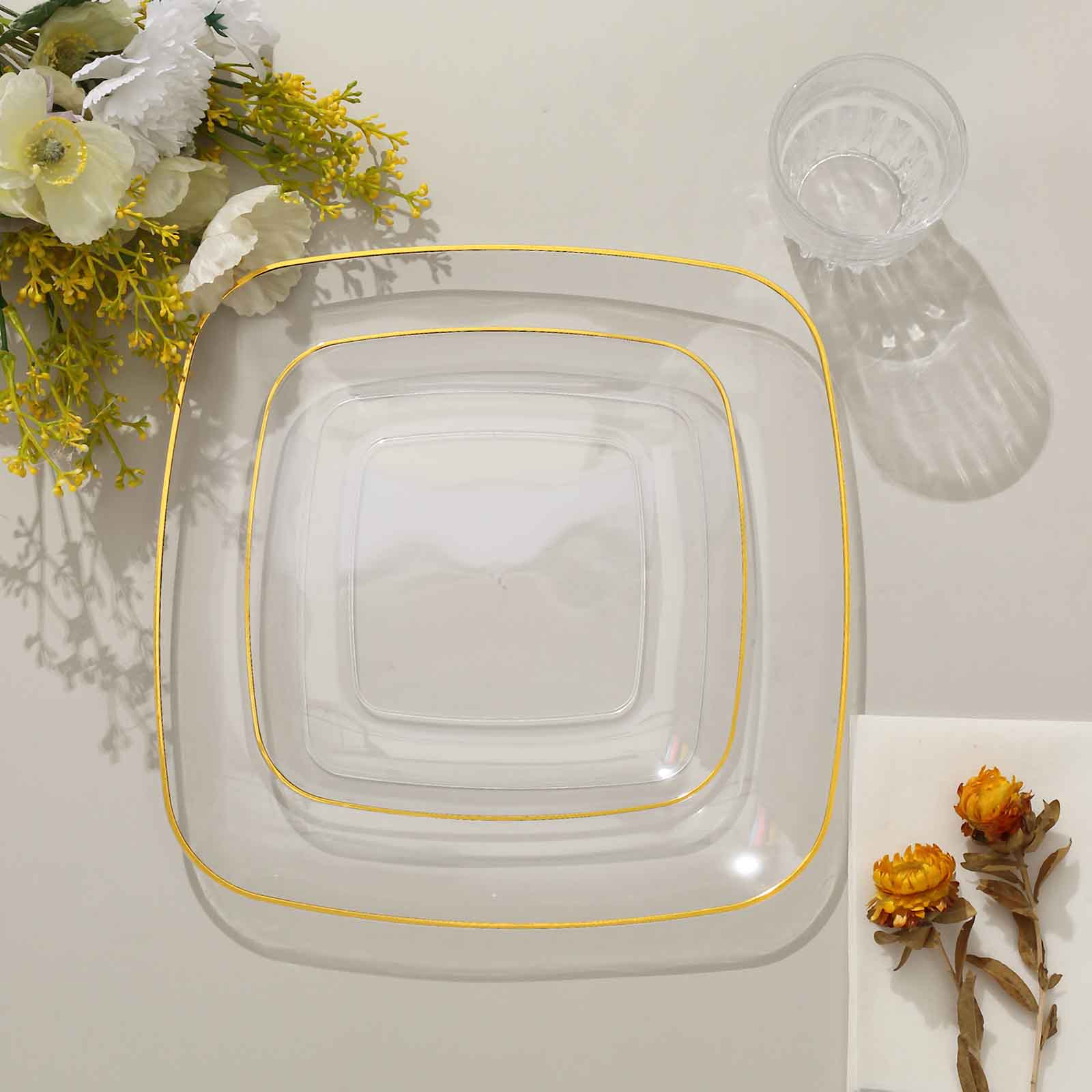 Clear plastic dessert plates with gold rim, perfect for parties and appetizers.