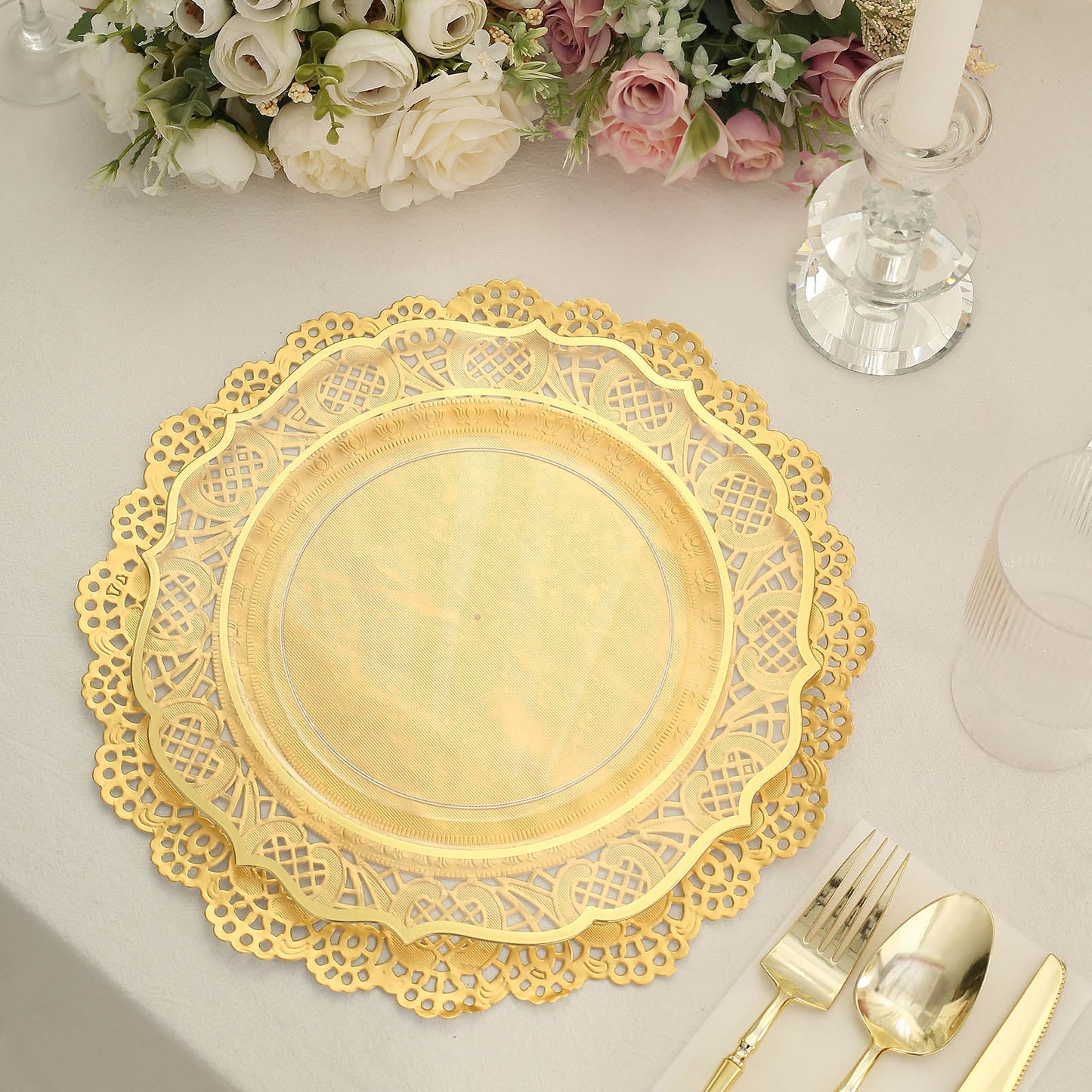 12" round gold lace paper doily on a table setting with floral accents.