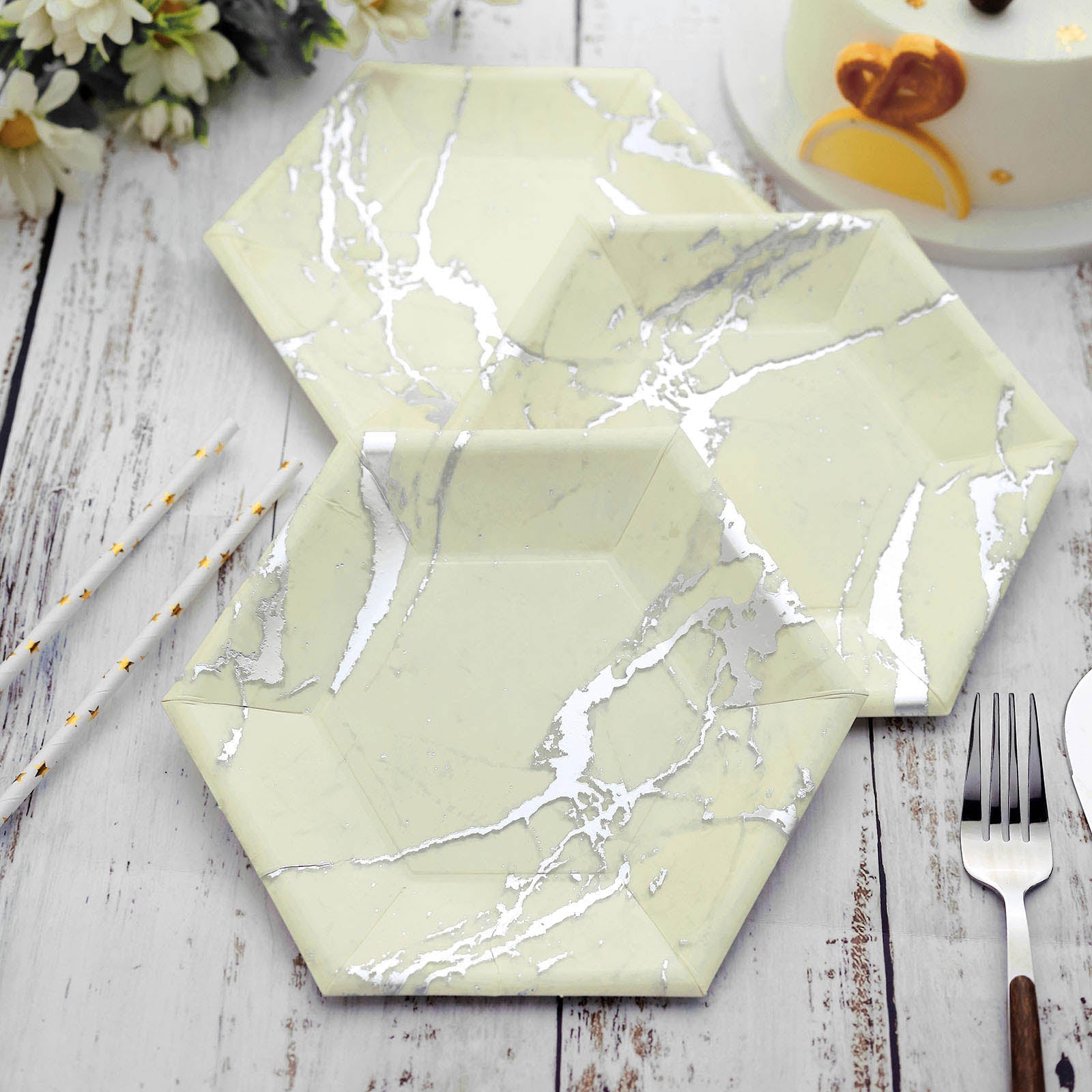 Ivory marble hexagon paper plates with silver foil design.