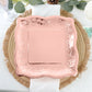 Rose gold vintage dinner plate with embossed scroll design.