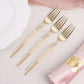 Gold glittered disposable forks on a table setting.