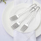 Silver disposable forks on a white plate.