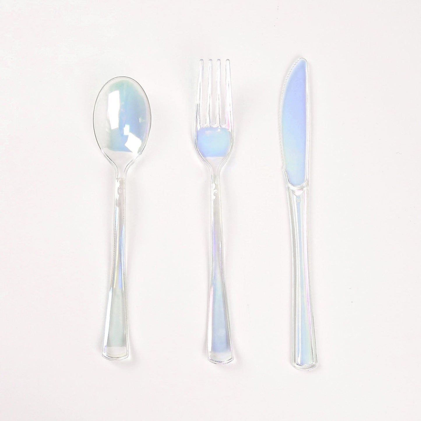 Iridescent disposable cutlery set, including a spoon, fork, and knife.
