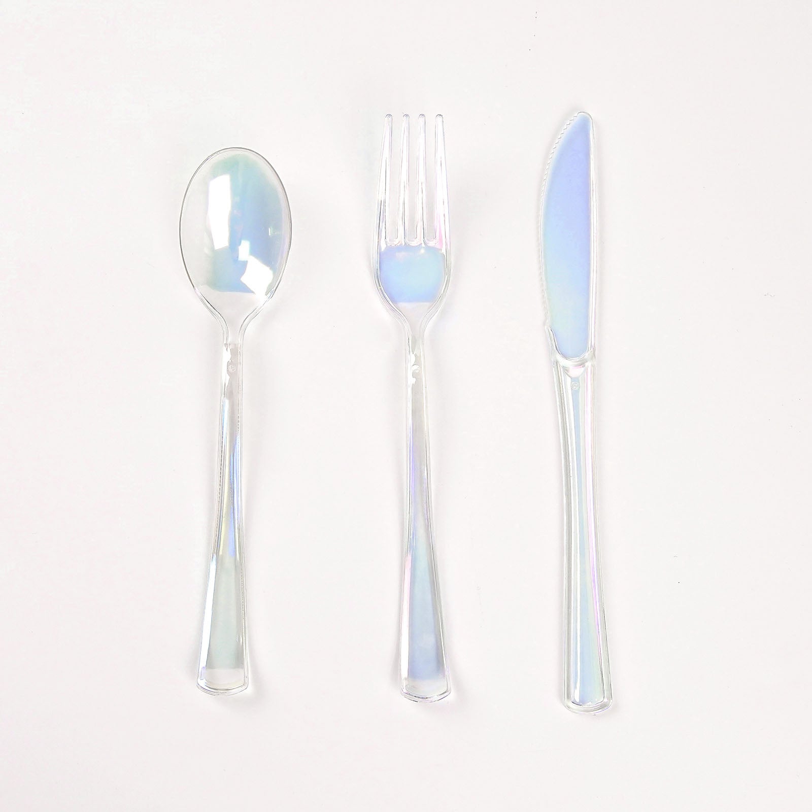 Iridescent disposable cutlery set, including a spoon, fork, and knife.