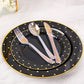 Iridescent disposable cutlery set on black plates with gold polka dots.