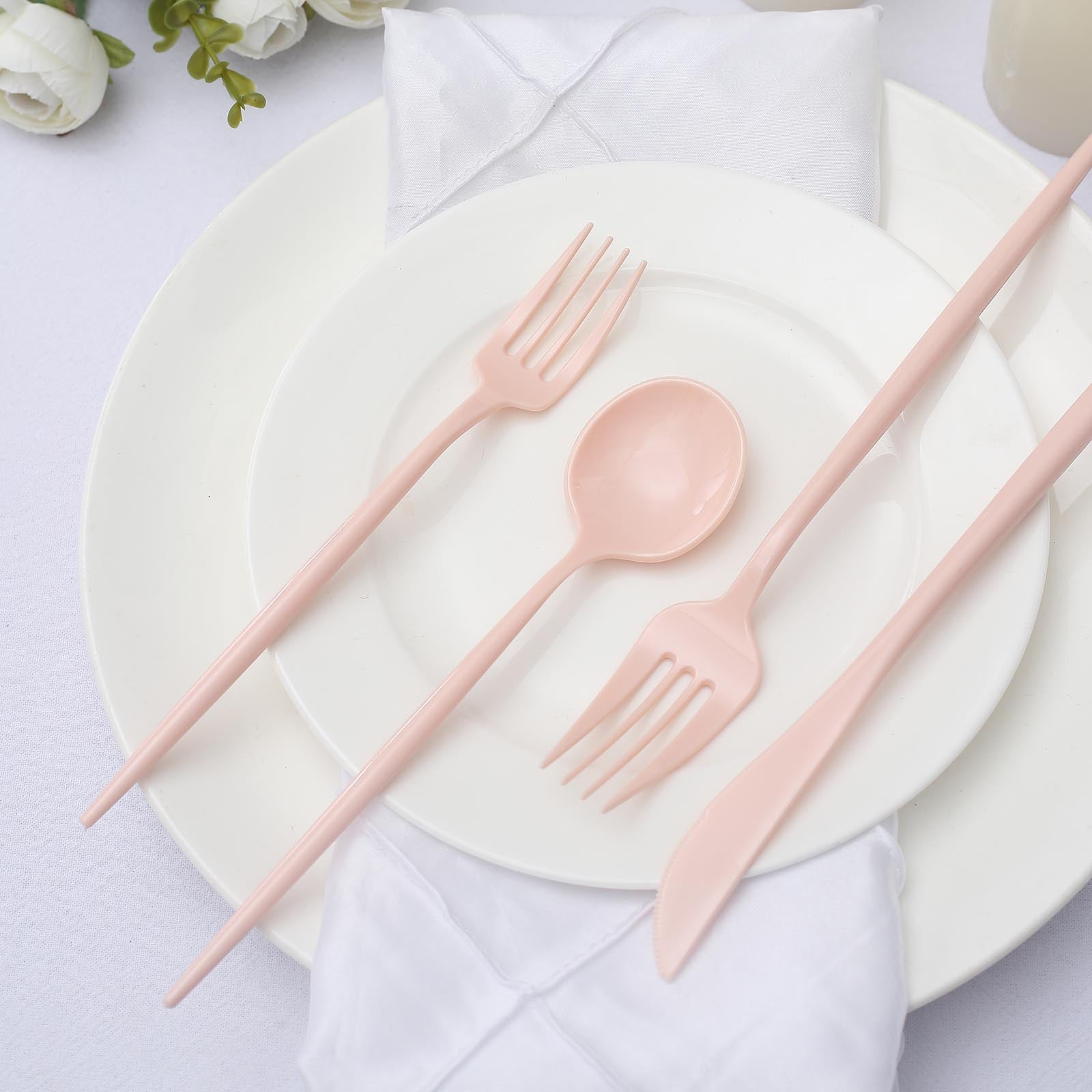 Blush pink disposable cutlery set on a white plate.