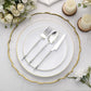Silver disposable utensil set with Roman column handle on elegant table setting.