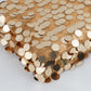 Gold sequin fabric roll with mesh, perfect for DIY crafts.