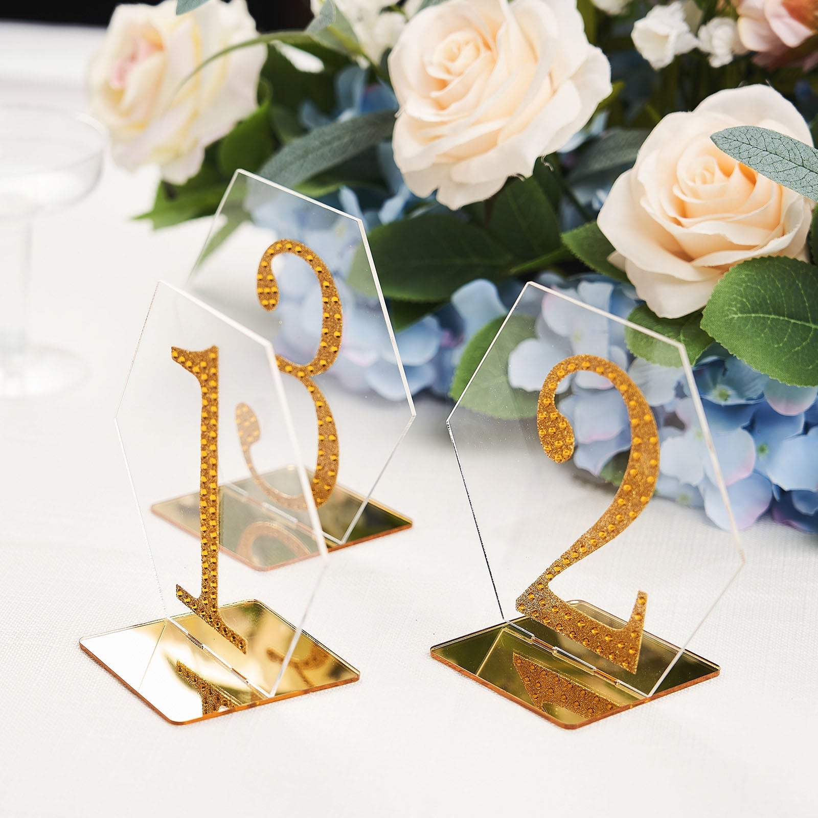 Clear and gold acrylic hexagon wedding table sign holders.