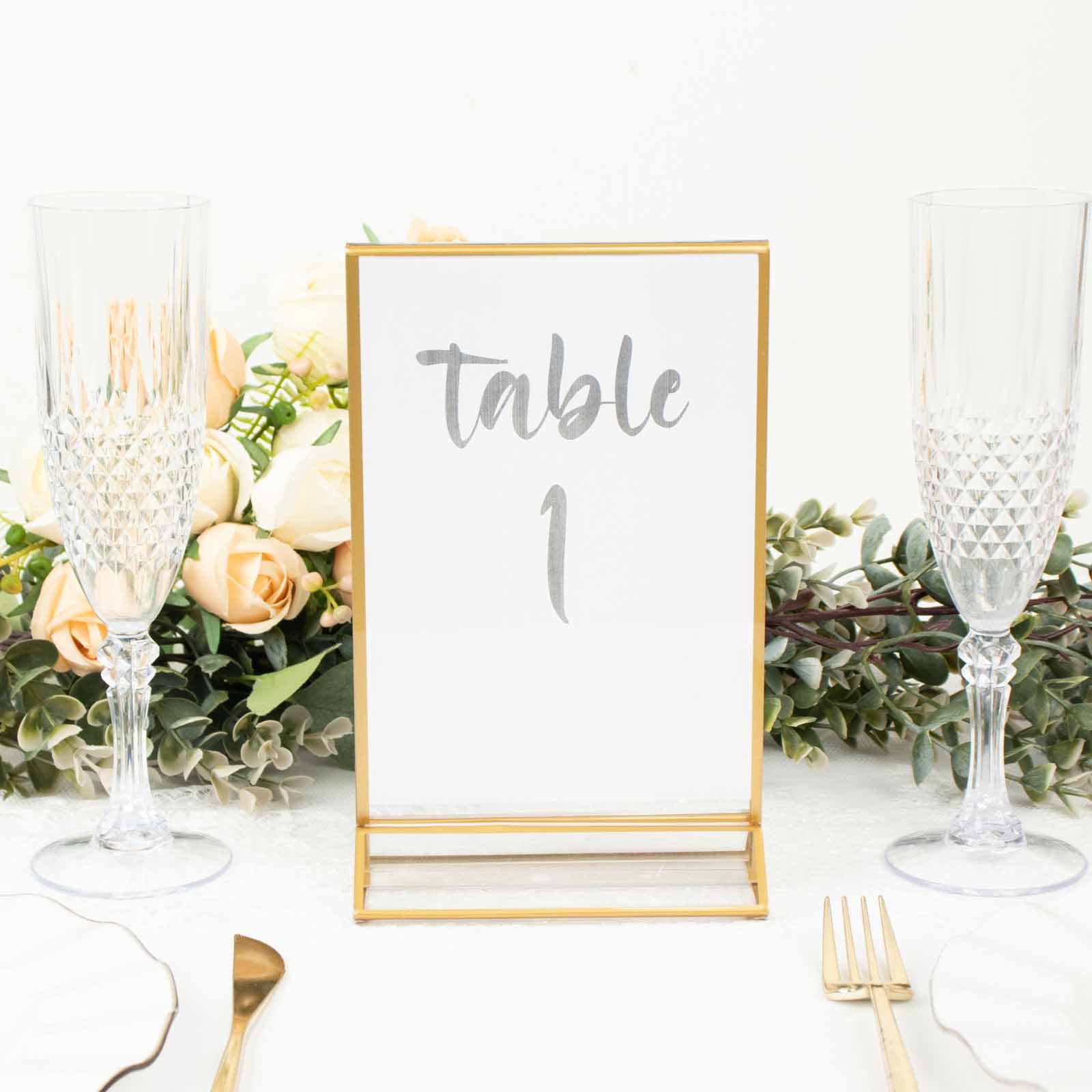 Gold frame acrylic table sign holder displaying "Table 1" with floral decor.