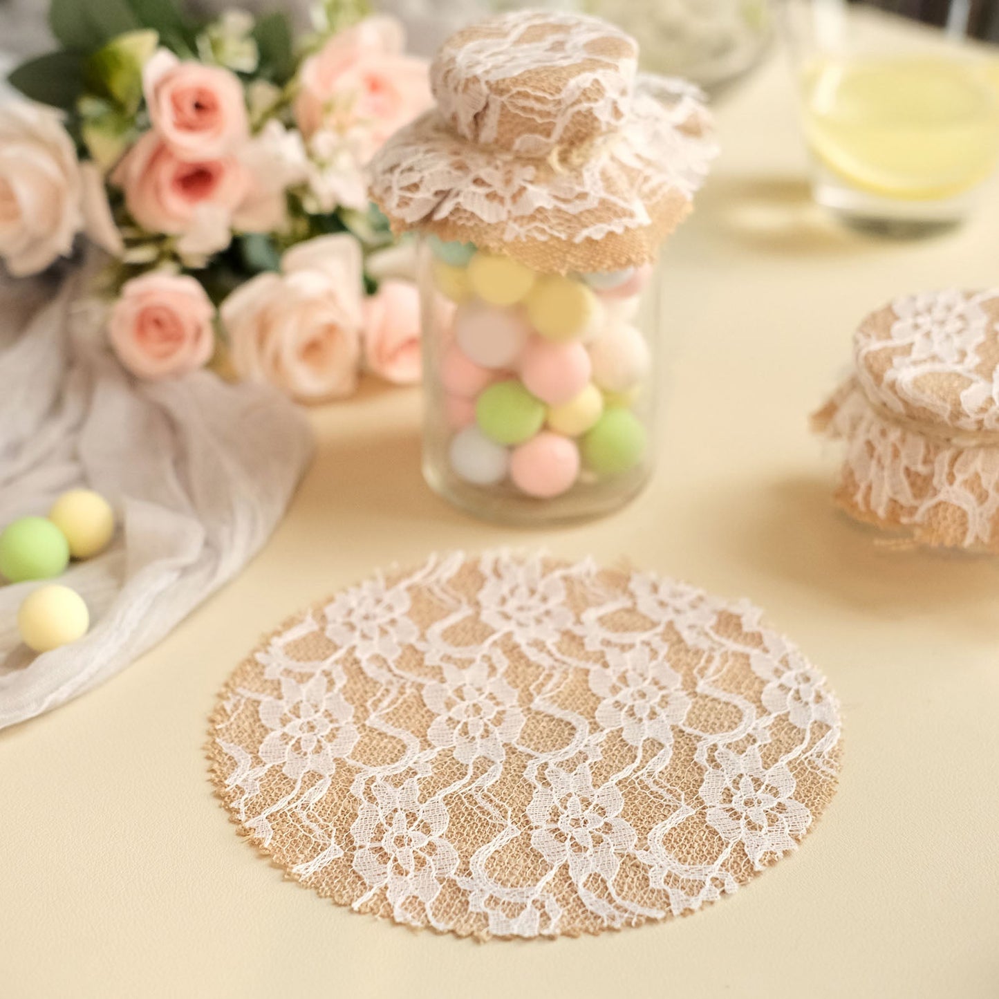Rustic burlap and white lace mason jar lid covers with jute string.