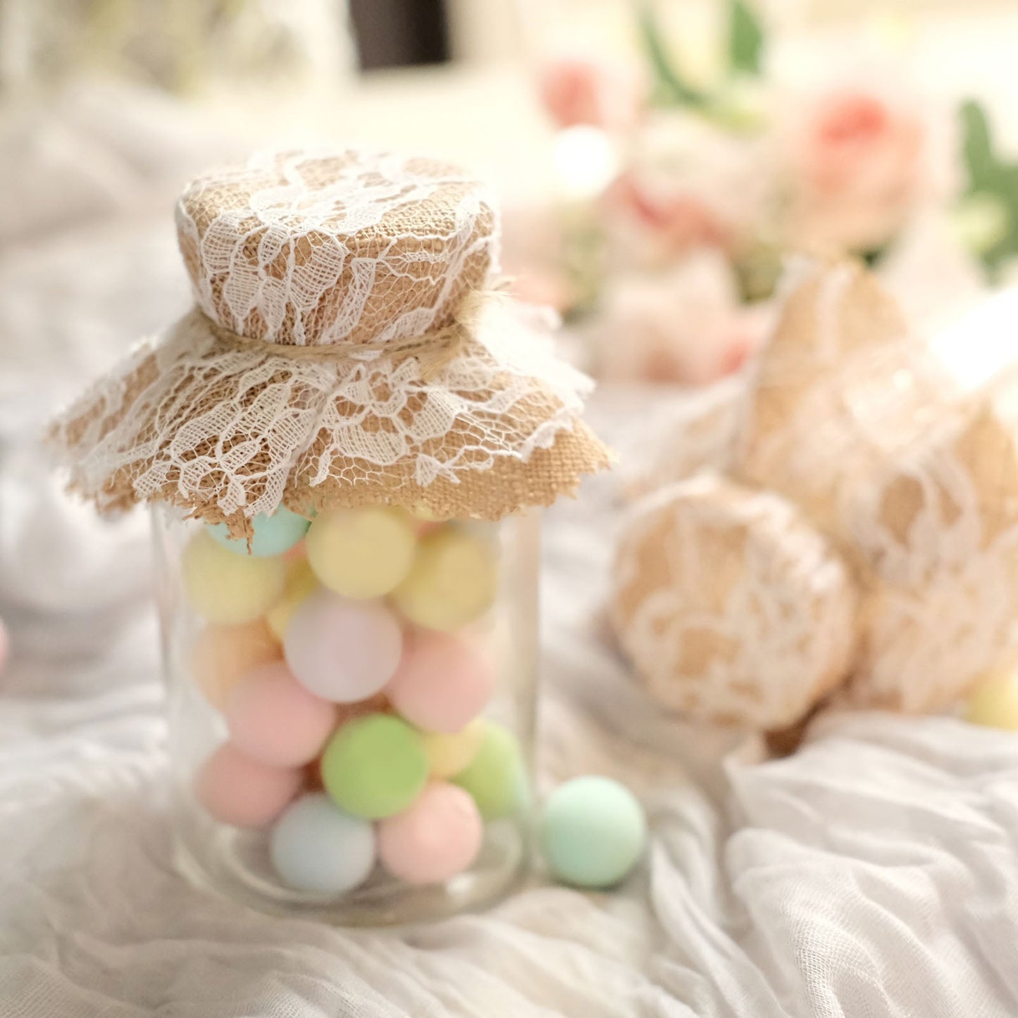 Rustic burlap and white lace mason jar lid covers with jute string.