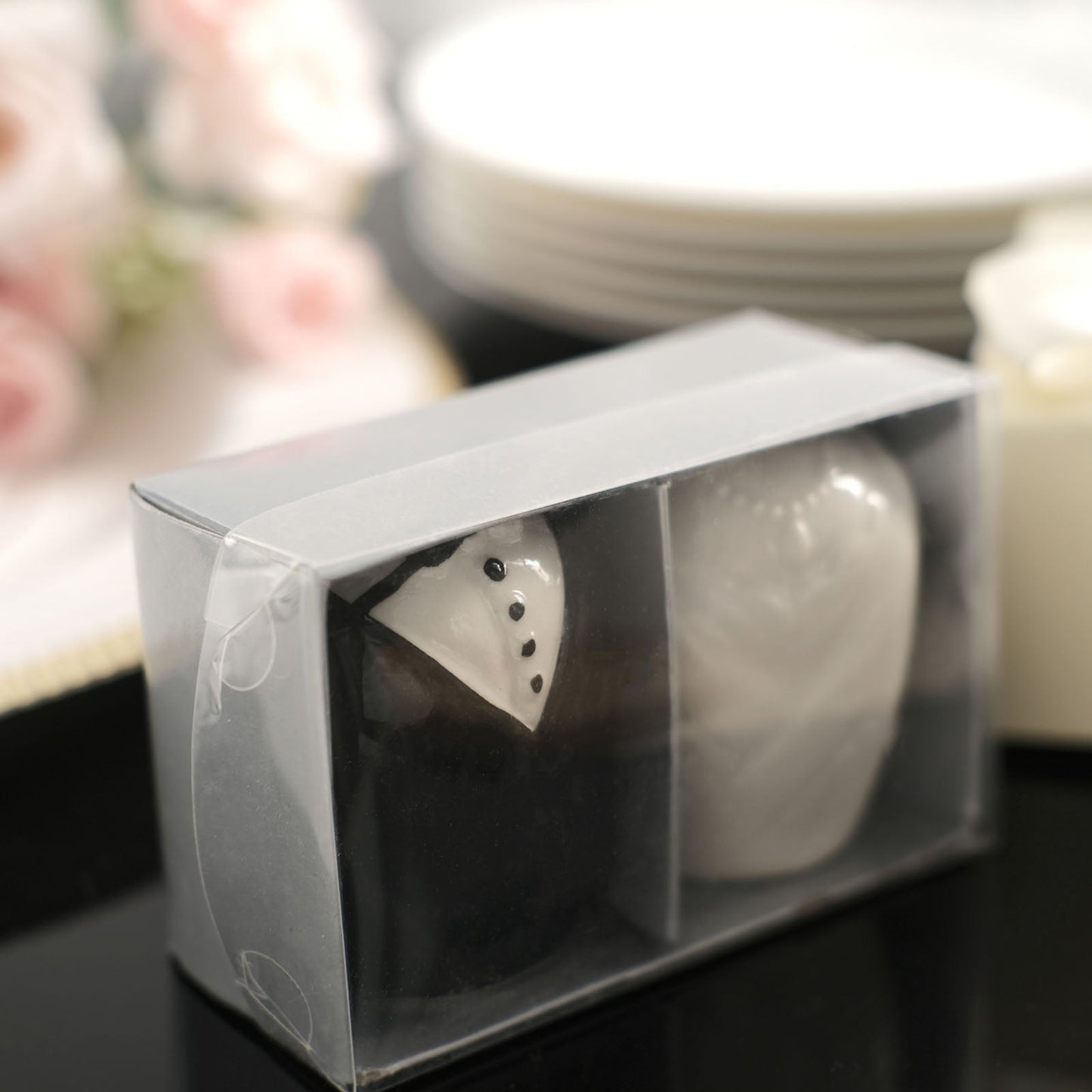 Bride and groom ceramic salt and pepper shakers in a gift box.
