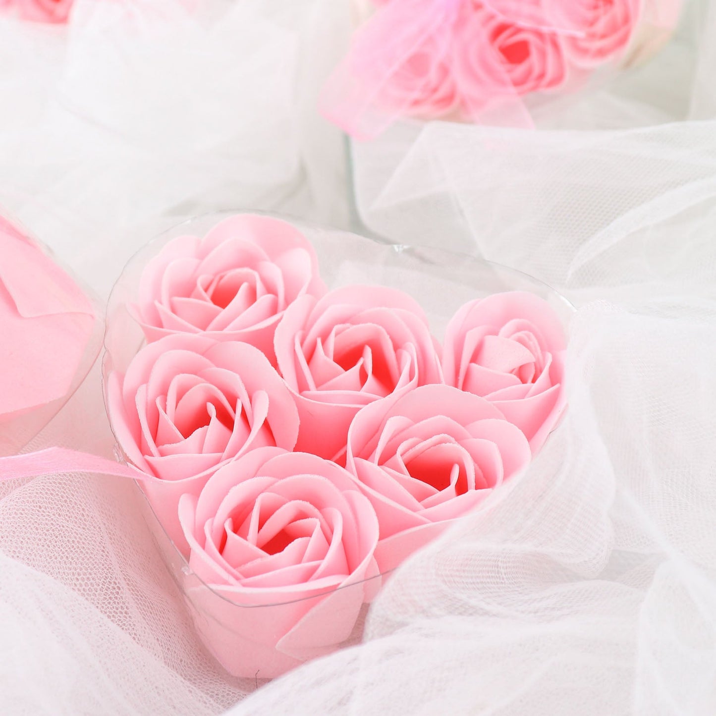 Blush pink rose soap heart shaped party favors in gift boxes with ribbon.