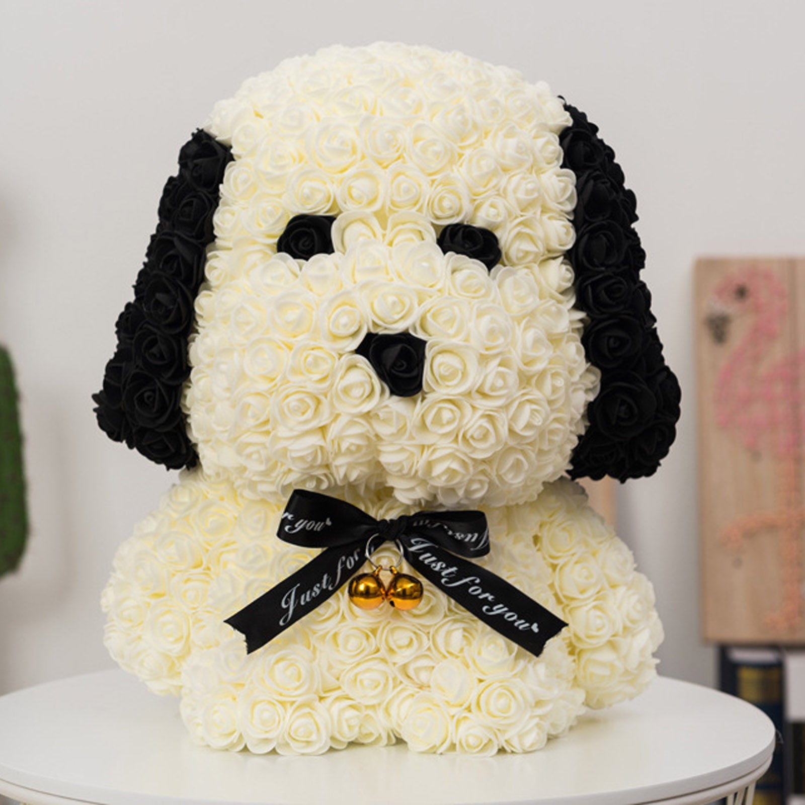 White 3D modeling styrofoam puppy with black accents and a decorative ribbon.