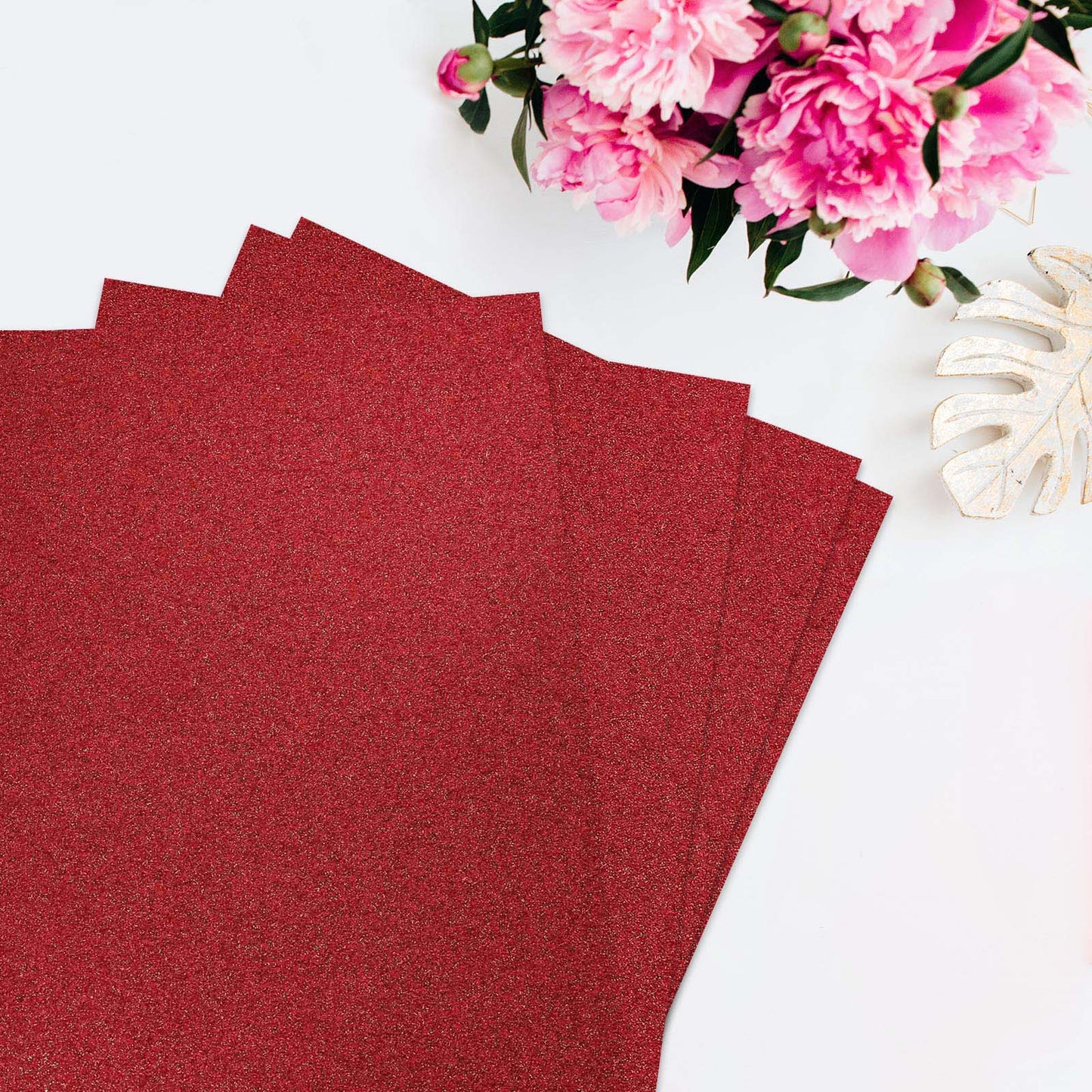 Burgundy self-adhesive glitter foam sheets arranged with flowers.