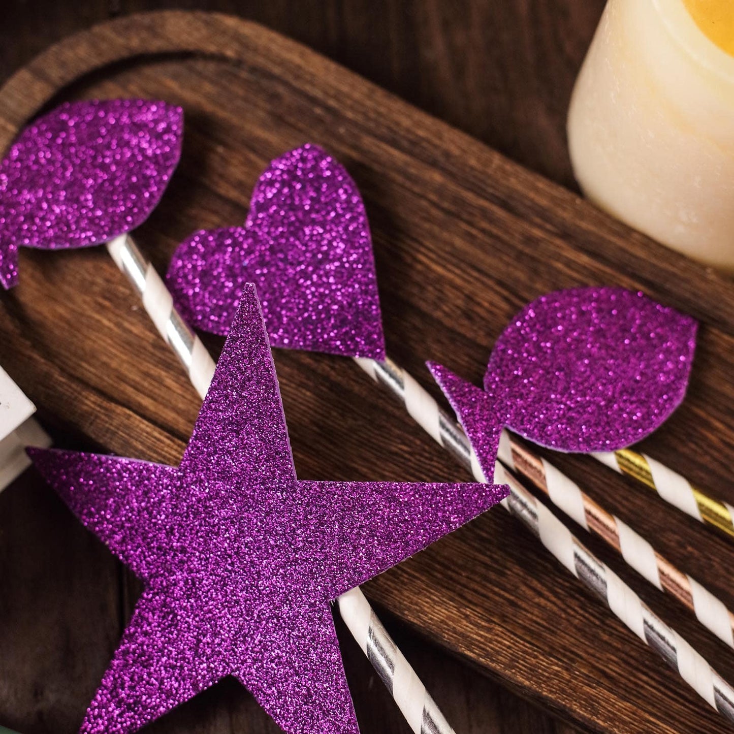 Purple self-adhesive glitter craft foam sheets arranged decoratively.