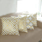 18" white and gold foil geometric print throw pillow covers on a sofa.