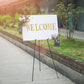 Black metal sign holder easel stand with welcome sign.