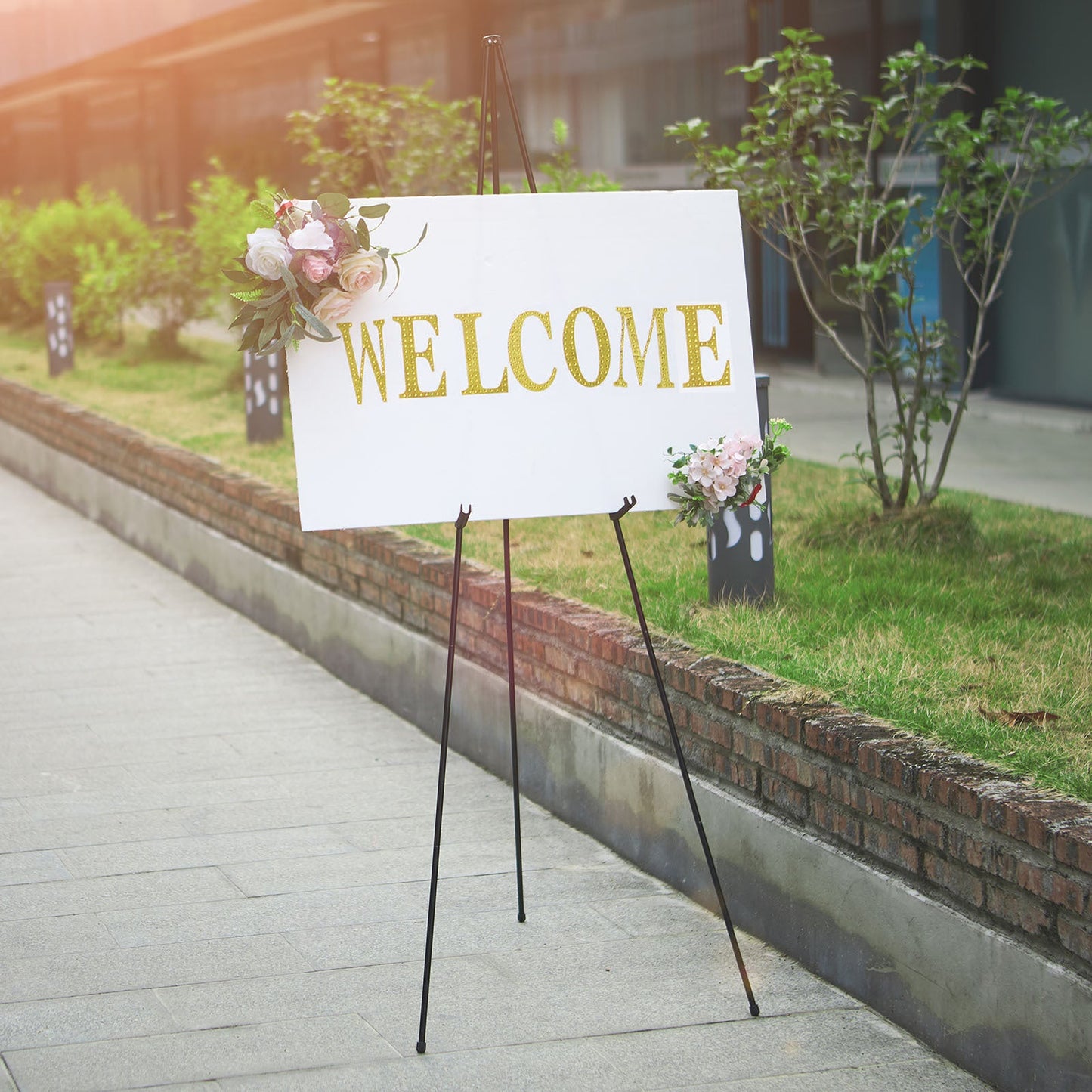 Black metal sign holder easel stand with welcome sign.