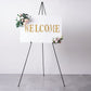 65" black metal easel stand with a welcome sign and floral accents.