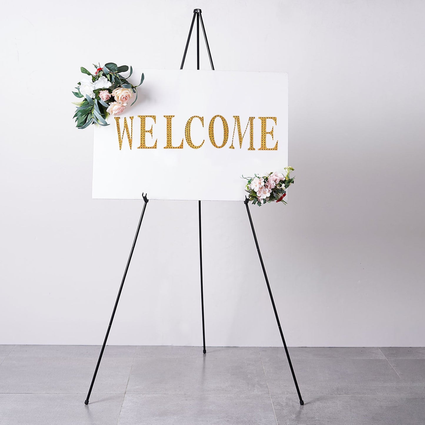 65" black metal easel stand with a welcome sign and floral accents.