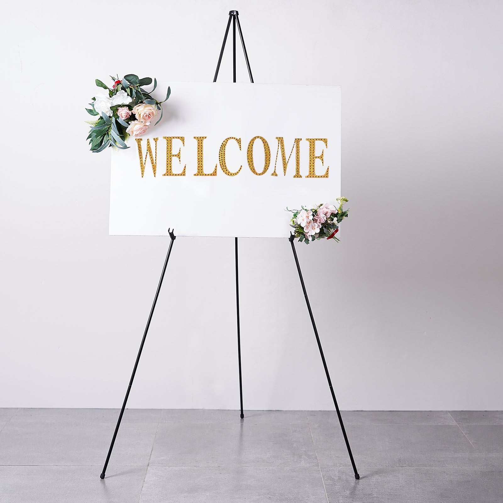 65" black metal easel stand with a welcome sign and floral accents.