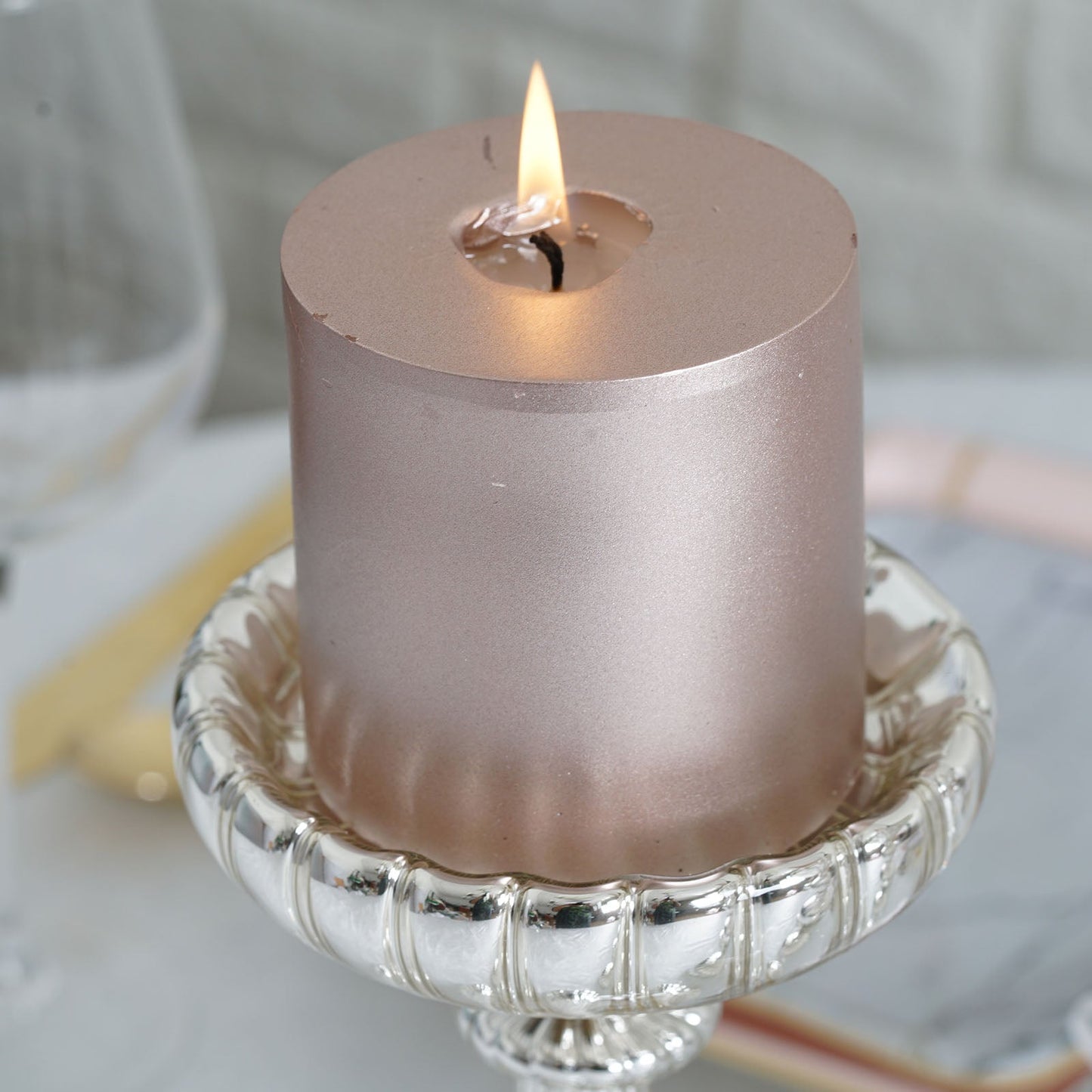Mercury silver glass candle holder with votive candle centerpiece.