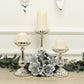 Mercury silver glass pillar candle holders with white candles and floral decor.
