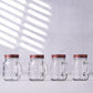 Rustic clear glass mason jars with rose gold lids.