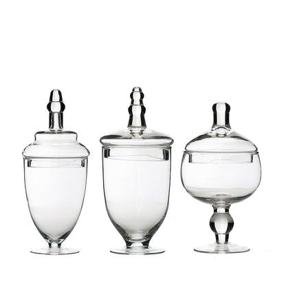 Clear apothecary glass jars with snap-on lids, decorative footed storage.