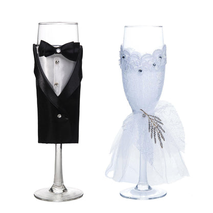 Set of 2 black and white wedding toast flutes with bride and groom designs.