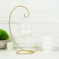 Gold metal air plant terrarium stand with hanging ornament display holder.