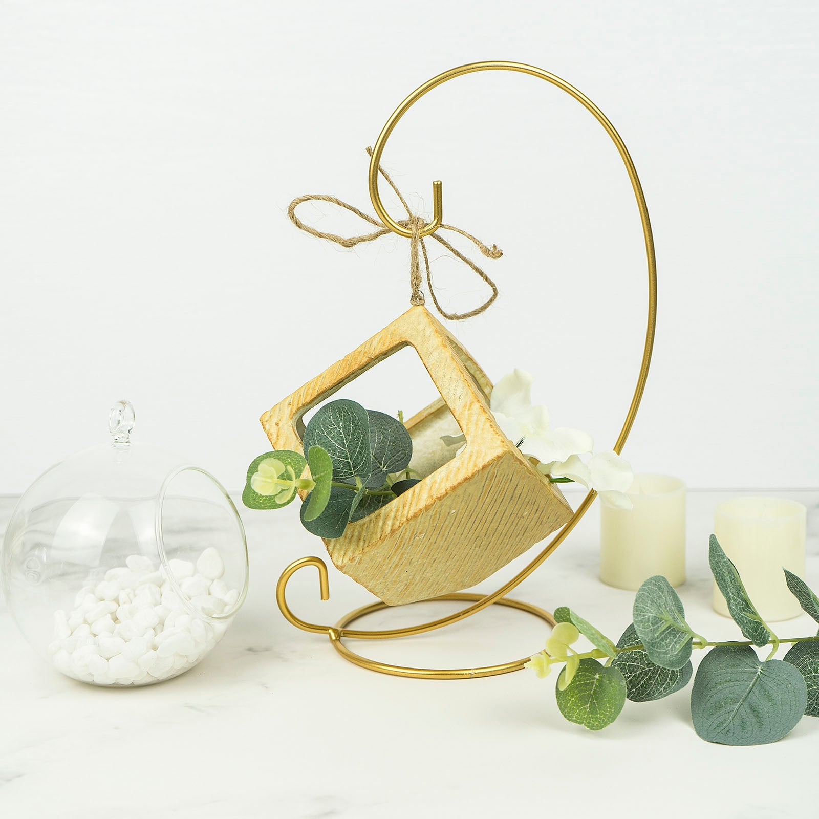 Gold metal air plant terrarium stand with hanging ornament display holder.