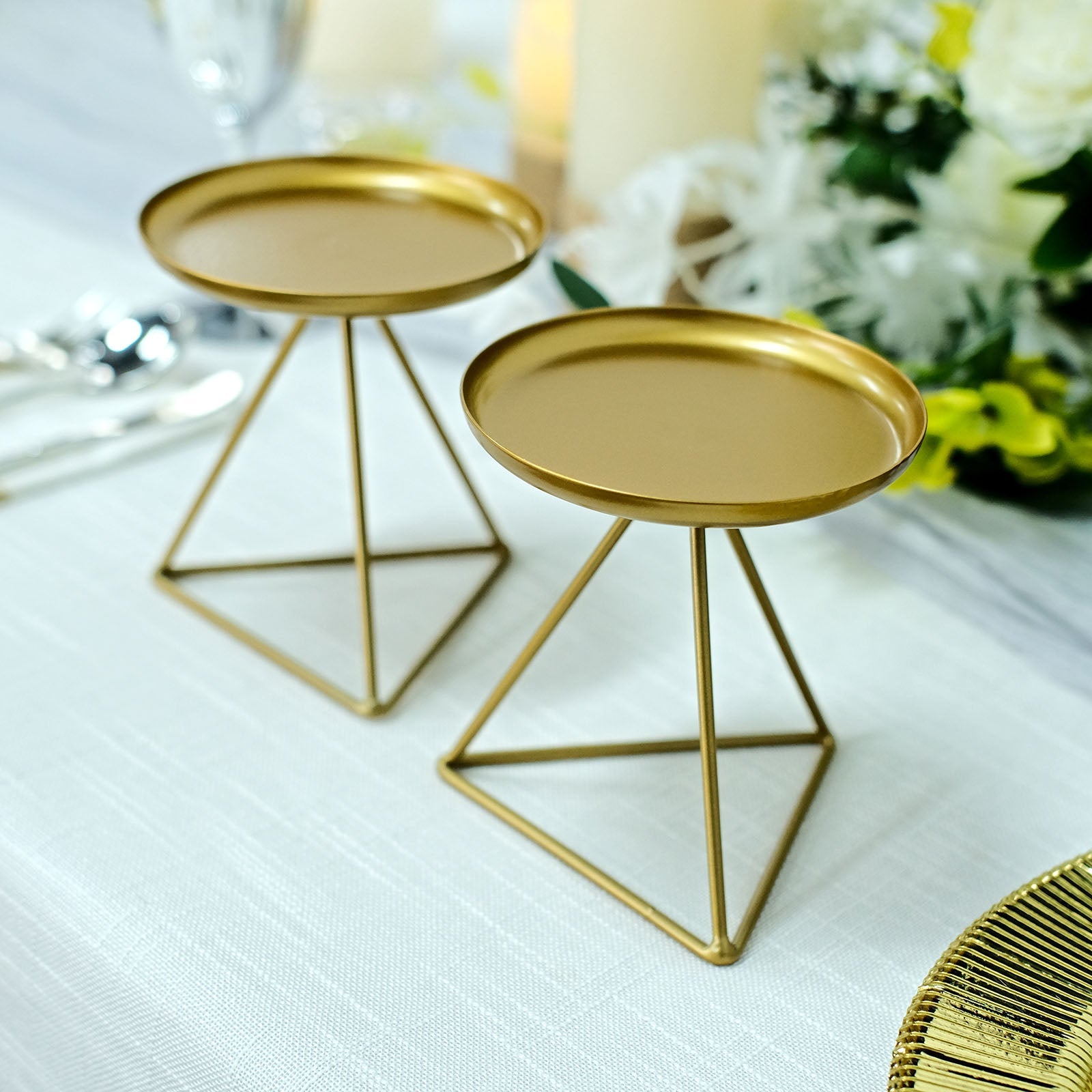 Gold metal triangle base candle holders, geometric table centerpieces.
