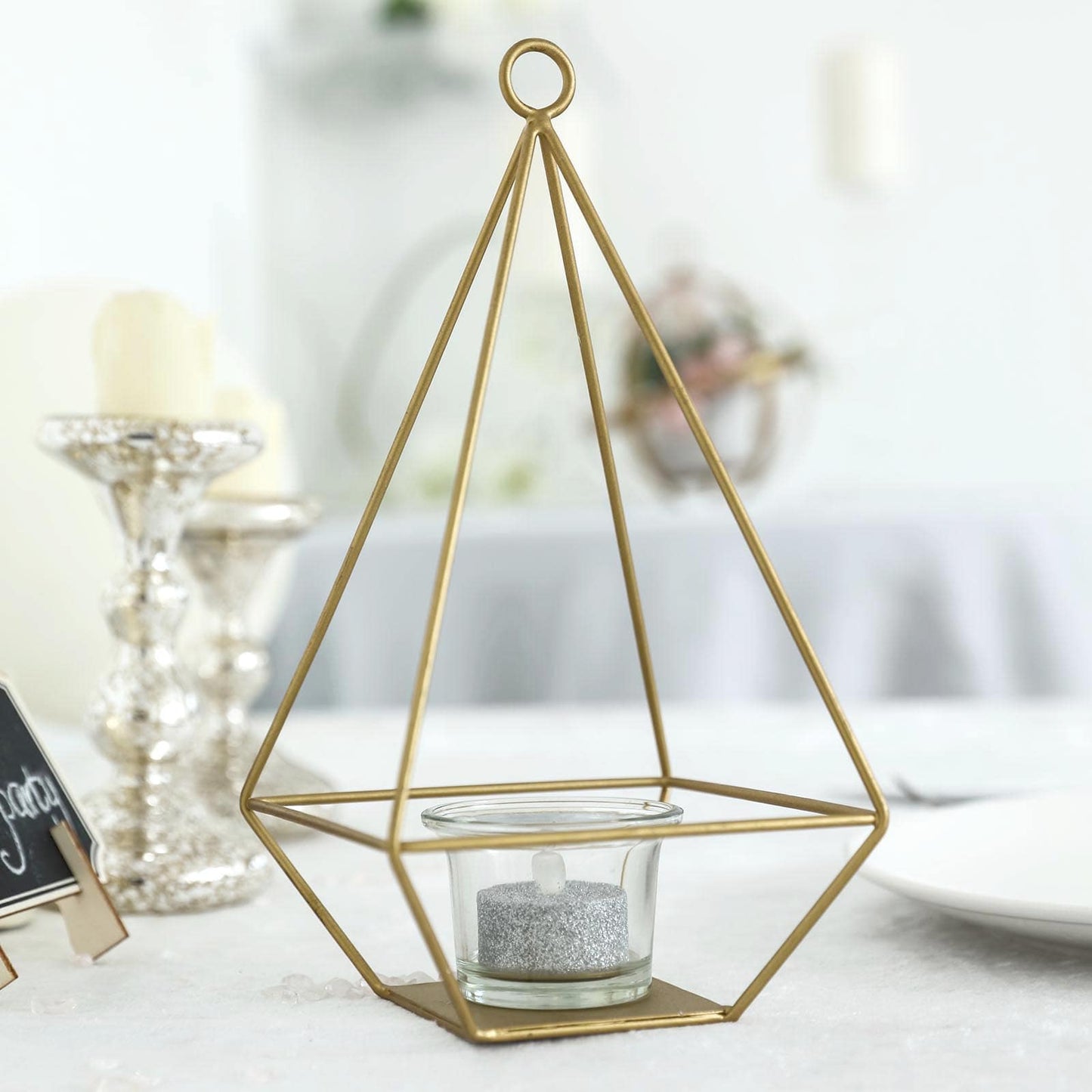 9" gold metal pyramid tealight candle holder with geometric design.