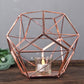 Rose gold geometric pentagon prism tealight candle holder.