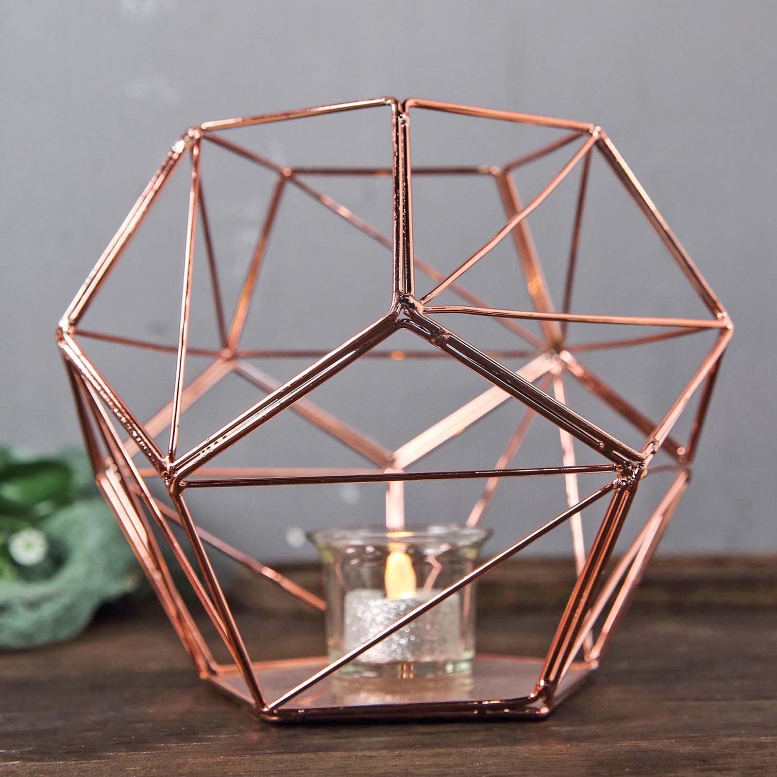 Rose gold geometric pentagon prism tealight candle holder.