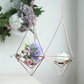 Rose gold geometric tealight candle holders with flowers.