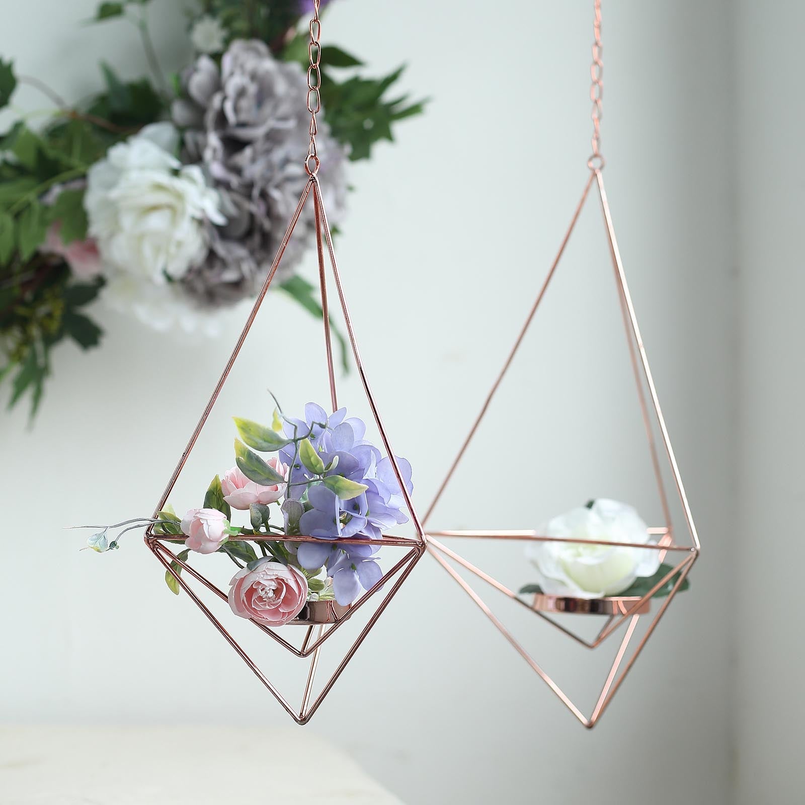 Rose gold geometric tealight candle holders with flowers.