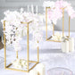 Gold rectangular geometric flower stand centerpiece with floral arrangement.