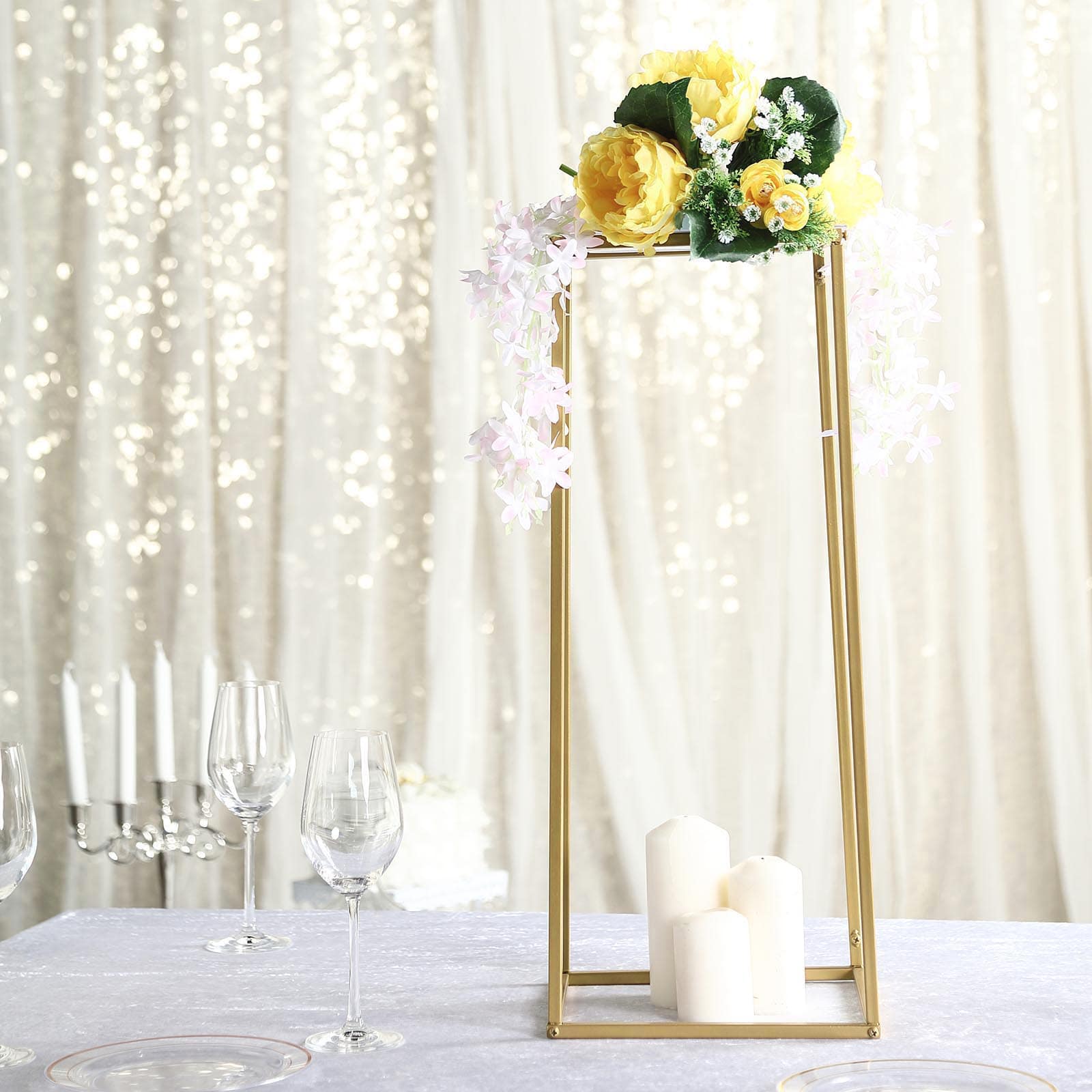 Gold rectangular flower stand centerpiece with floral arrangement.