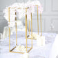 Gold geometric wedding flower stands with floral arrangements.