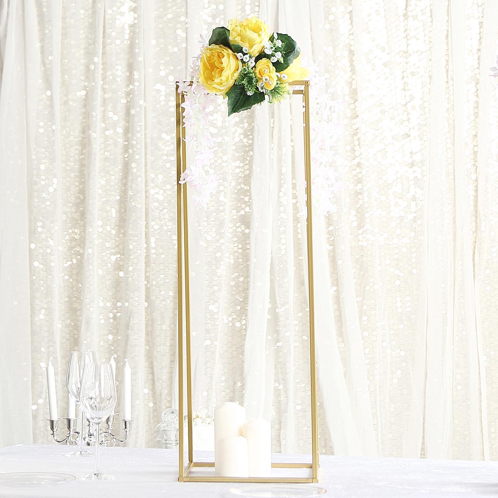 Gold metal rectangular wedding flower stand with floral arrangement.
