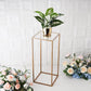 Clear acrylic plexiglass sheets on a gold plant stand with greenery.