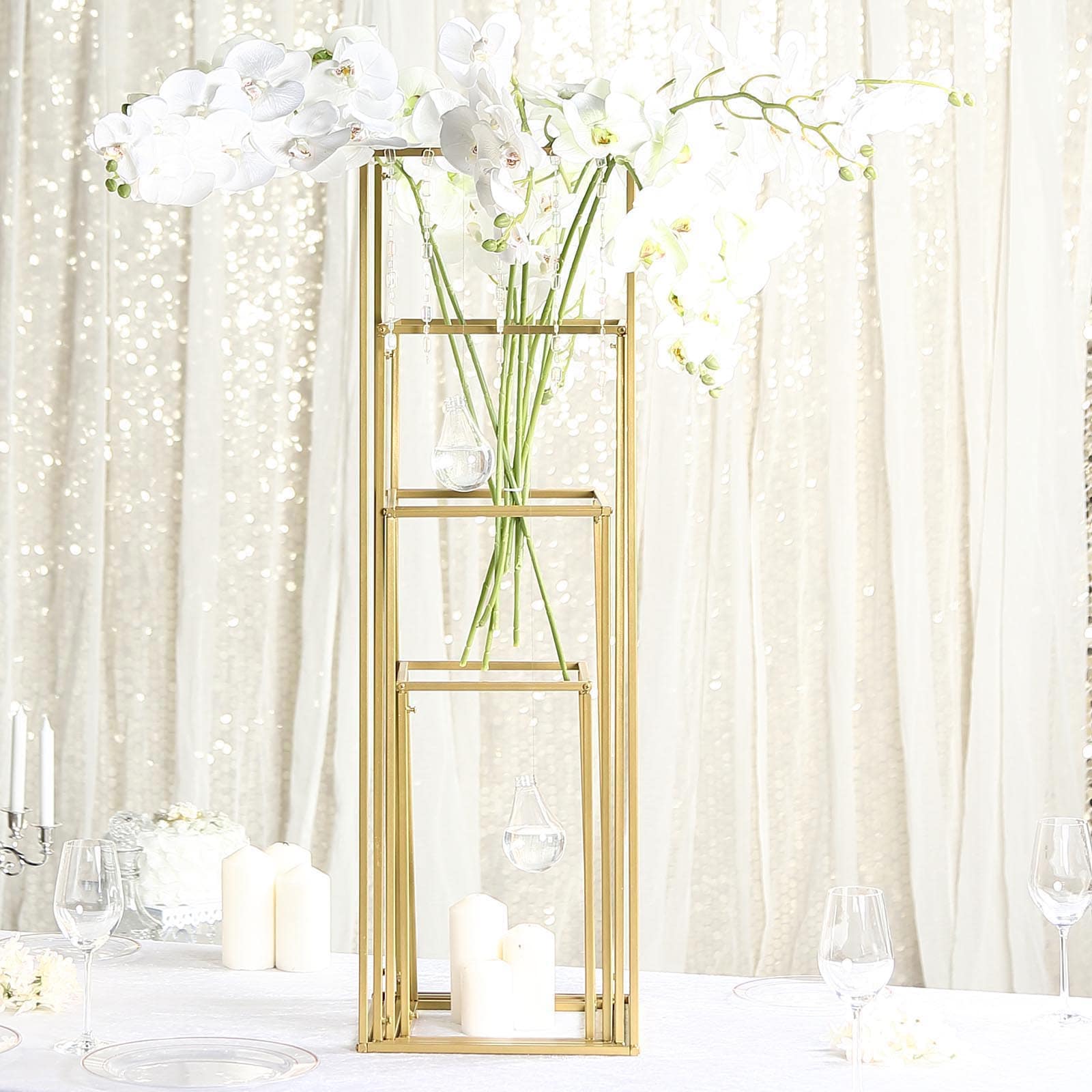 Matte gold metal frame flower stand centerpiece with elegant white orchids.