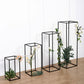 Matte black metal frame flower stands in various heights with floral accents.