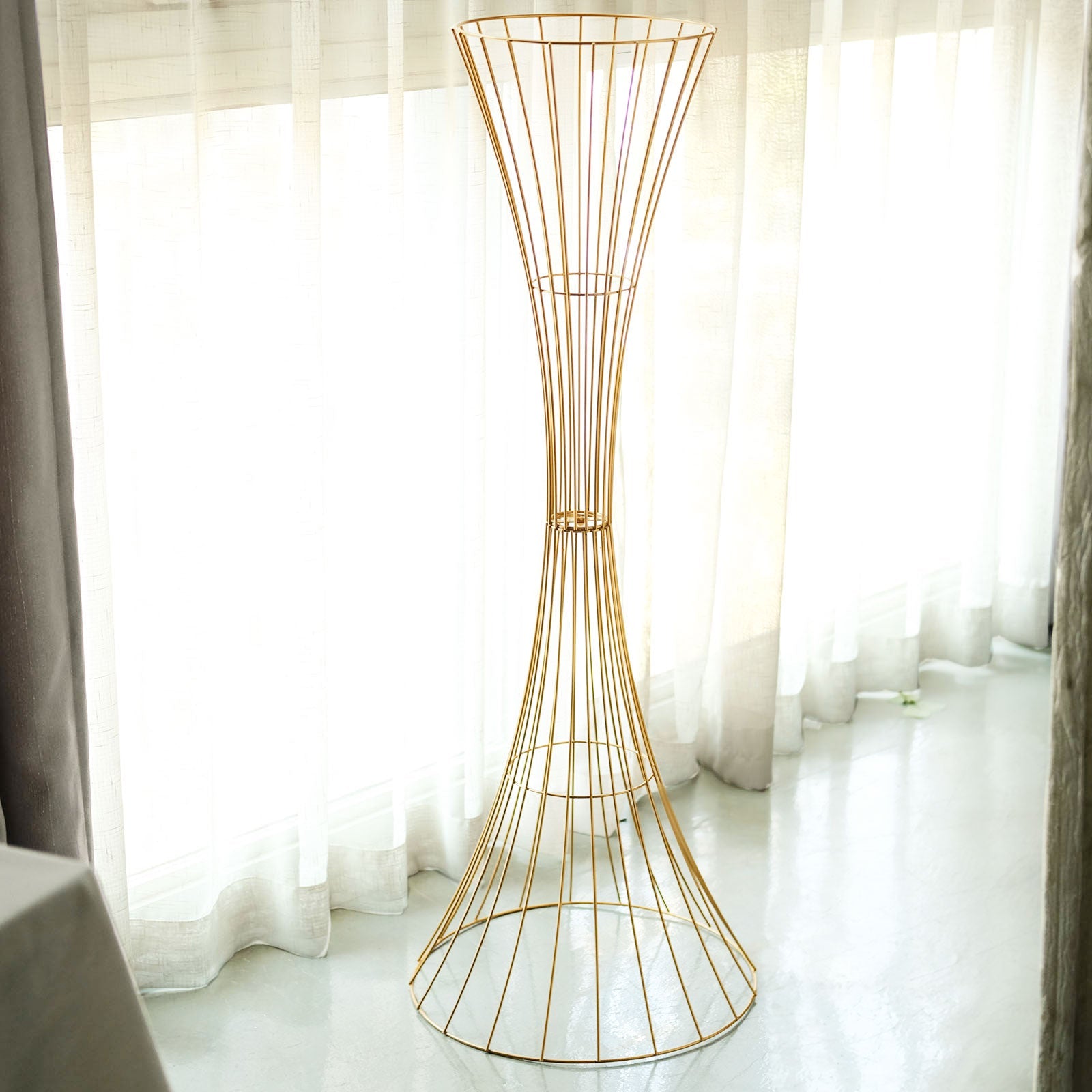 Gold metal wire trumpet-shaped flower centerpiece stand.