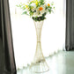 Gold metal wire trumpet-shaped flower centerpiece stand with floral arrangement.